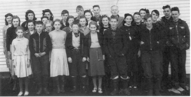 527: Group of 27 children. (circa 1950) [courtesy of Lorna Richardson] ** also see 526 **  Back-to-front, left-to-right,  Margie Norman (back), Beth Lambe (middle), Babe Ennis (front, white skirt);  Angela Ryan (back), Mary Finn (middle), Francis Barry (front);  Marie Ryan (back), Annie Norman (2nd from back, partially hidden), Madonna McCarthy (3rd  from back, blonde hair), Madonna Whelan (front, white skirt);  Gerard Lambe (back), Imelda Ryan (middle), Dave Ryan (front);  Paul McCarthy (back), Gwen Carroll (2nd from back), Noreen Ryan (3rd from back),  Mary Ennis (front); Camillus Dunphy (back), Teresa Whelan (middle, big smile),  Patrick Lambe (front); Mr. Denis Patrick Barry (back, schoolmaster), Marie Counsel, Kevin Ryan,  Betty Ennis (back), Thomas Barry (front), Adrian Ryan, Joseph Dunphy, Kevin Carroll.  - Francis Barry (of Thomas Barry &amp;amp; Catherine Corrigan)  - Thomas Barry (of Thomas Barry &amp;amp; Anne Dollimont)  - Gwen Carroll (of Michael Carroll &amp;amp; Josephine Barry)  - Kevin Carroll (of Michael Carroll &amp;amp; Josephine Barry)  - Marie Counsel (of Michael Counsel &amp;amp; Mary Anne Barry)  - Camillus Dunphy (of Thomas Dunphy &amp;amp; Anastasia Carroll)  - Joseph Dunphy (of Thomas Dunphy &amp;amp; Anastasia Carroll)  - Babe Ennis (of Vincent Ennis &amp;amp; Mary Carroll)  - Betty Ennis (of Vincent Ennis &amp;amp; Mary Carroll)  - Mary Ennis (of Vincent Ennis &amp;amp; Mary Carroll)  - Mary Finn (of Patrick Finn &amp;amp; Helena Hayward)  - Beth Lambe (of James Lambe &amp;amp; Catherine Rodgers)  - Gerard Lambe (of Peter Lambe &amp;amp; Anne Norman)  - Patrick Lambe (of Peter Lambe &amp;amp; Anne Norman)  - Madonna McCarthy (of James McCarthy &amp;amp; Mary Ellen Barry)  - Paul McCarthy (of Thomas McCarthy &amp;amp; Margaret Whelan)  - Annie Norman (of John Norman &amp;amp; Mary Farget)  - Margie Norman (of Charles Norman &amp;amp; Elizabeth Anne Barry)  - Adrian Ryan (of Albert Ryan &amp;amp; Catherine Nolan)  - Angela Ryan (of Michael Ryan &amp;amp; Petronella Whelan)  - David Ryan (of Jeremiah Ryan &amp;amp; Josephine Lambe)  - Imelda Ryan (of Jeremiah Ryan &amp;amp; Josephine Lambe)  - Kevin Ryan (of Albert Ryan &amp;amp; Catherine Nolan)  - Marie Ryan (of Joseph Ryan &amp;amp; Ursula Barry)  - Noreen Ryan (of Albert Ryan &amp;amp; Catherine Nolan)  - Madonna Whelan (of Leo Whelan &amp;amp; Elizabeth Bishop)  - Teresa Whelan (of Leo Whelan &amp;amp; Elizabeth Bishop)